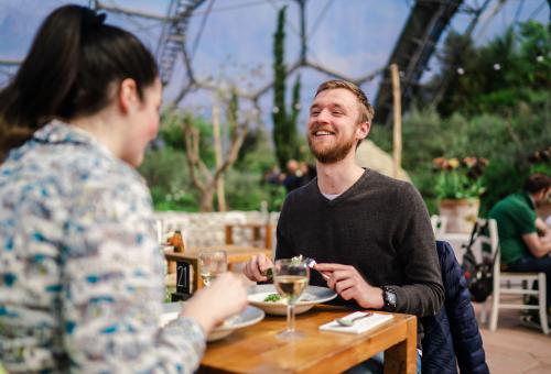 Couple enjoying food and drinks in our Med Terrace